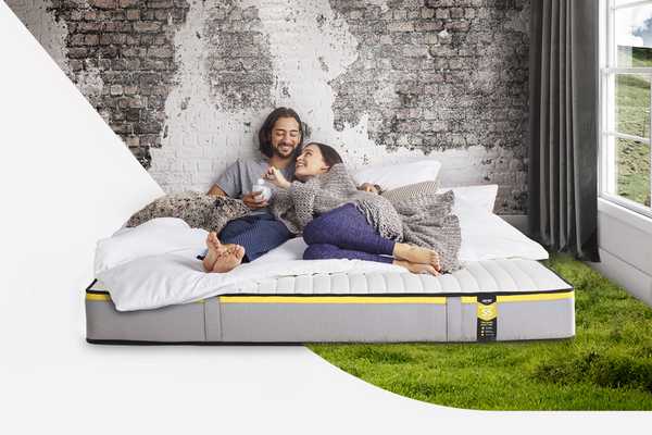 A couple relaxing on Jay-Be Benchmark S5 hybrid eco-friendly mattress.